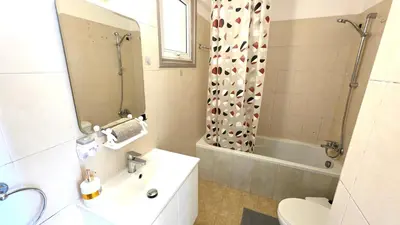 a bathroom with a sink and a toilet and a shower at Stylish 2BR Apartment with Balcony, Wifi & Pool in Larnaka