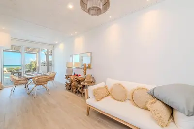 a living room with a white couch and a table at Ayia Thekla Beach House in Ayia Napa