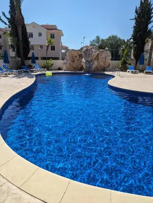 a large pool with blue water in a resort at Pyla Village Resort - F302 in Pyla