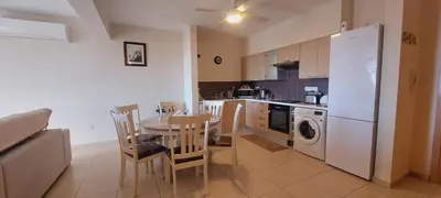 a kitchen with a table and chairs and a refrigerator at Pyla Village Resort - F302 in Pyla