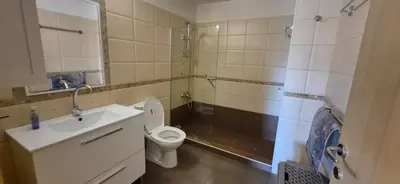 a bathroom with a toilet and a shower and a sink at Pyla Village Resort - F302 in Pyla