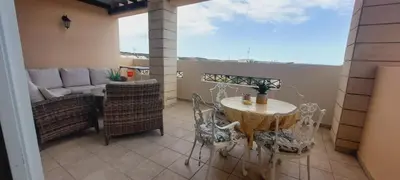 a balcony with a table and chairs and a couch at Pyla Village Resort - F302 in Pyla