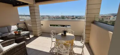 a patio with a table and chairs on a balcony at Pyla Village Resort - F302 in Pyla
