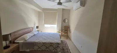 a bedroom with a bed and a ceiling fan at Pyla Village Resort - F302 in Pyla
