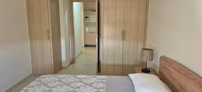a bedroom with a bed and a door to a hallway at Pyla Village Resort - F302 in Pyla