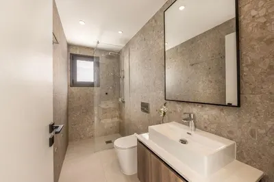 a bathroom with a sink and a toilet and a mirror at Villa Nissi 1 in Ayia Napa