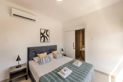 a bedroom with a bed with two towels on it at Villa Nissi 1 in Ayia Napa