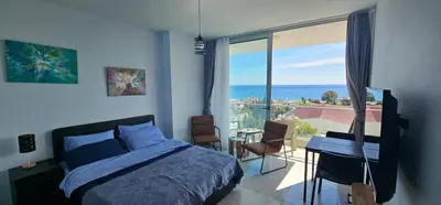 a bedroom with a bed and a view of the ocean at Muhteşem Deniz Manzaralı Stüdyo in Iskele