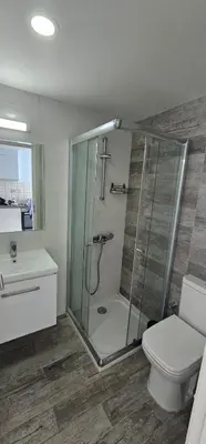 a bathroom with a shower and a toilet and a sink at Muhteşem Deniz Manzaralı Stüdyo in Iskele