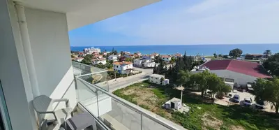 a balcony with a view of a city and the ocean at Muhteşem Deniz Manzaralı Stüdyo in Iskele