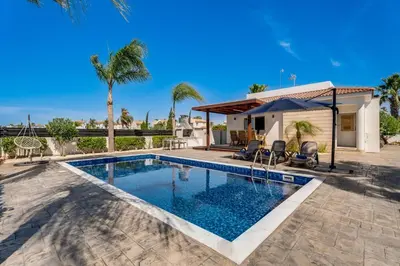 a villa with a swimming pool and a house at Casa Giovanni By Ezoria Villas in Ayia Napa