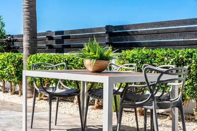a table and chairs with a potted plant on it at Casa Giovanni By Ezoria Villas in Ayia Napa