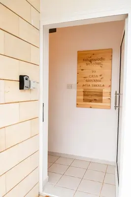 a door into a bathroom with a sign on the wall at Casa Giovanni By Ezoria Villas in Ayia Napa