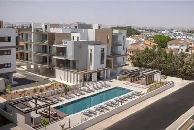 an aerial view of a building with a swimming pool at Kalamon Luxury Suite 203 w Pool and Gym in Livadhia