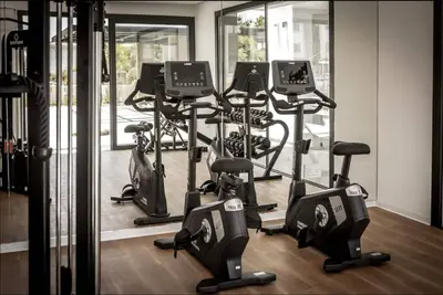 a gym with a bunch of exercise bikes in it at Kalamon Luxury Suite 203 w Pool and Gym in Livadhia