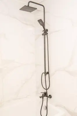 a shower with a shower head in a bathroom at Kalamon Luxury Suite 105 w Pool & Gym in Livadhia