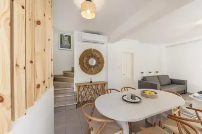 a kitchen and living room with a table and chairs at Protaras Utopia in Protaras