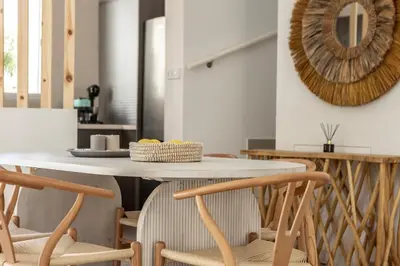 a kitchen with a table with chairs and a mirror at Protaras Utopia in Protaras