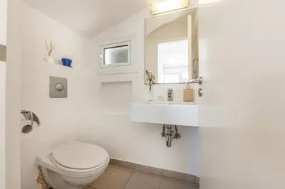 a bathroom with a toilet and a sink and a mirror at Protaras Utopia in Protaras
