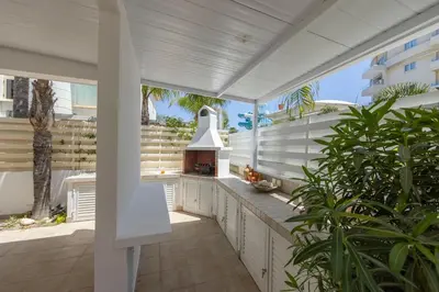an outdoor kitchen with a stove on a patio at Protaras Utopia in Protaras