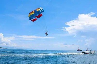 a person para sailing in the ocean with a parachute at Iliada Beach Hotel in Protaras