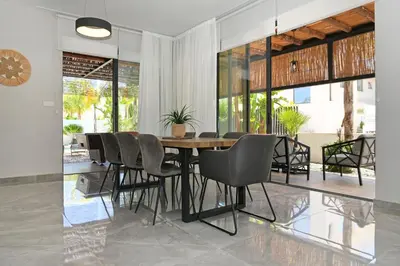 a dining room with a table and chairs at Villa Evergreen - 3bed Bungalow large pool in Protaras