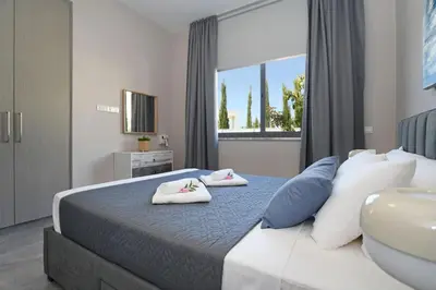 a bedroom with a bed with two towels on it at Villa Evergreen - 3bed Bungalow large pool in Protaras