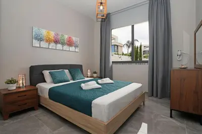 a bedroom with a bed and a large window at Villa Violeta - 3bed Bungalow large pool in Protaras