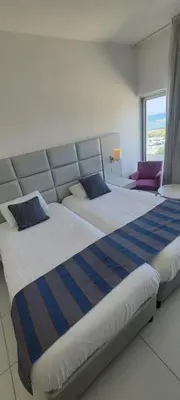 a hotel room with two beds and a window at Silver Sands Beach Hotel in Protaras