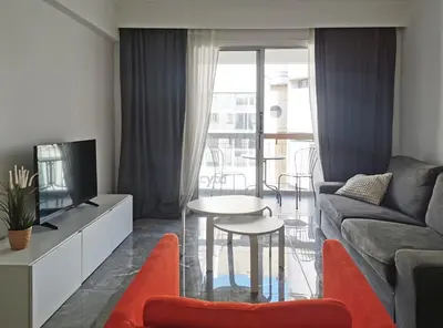 a living room with a couch and a table at Naxou Modern Residence By Staycom in Nicosia