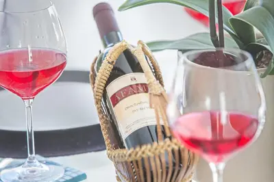 a bottle of wine and a glass of red wine at Narcissos Bay View Villa in Protaras
