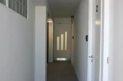 a hallway with a hallway leading to a room with a door at Nicosia Central Suites in Nicosia