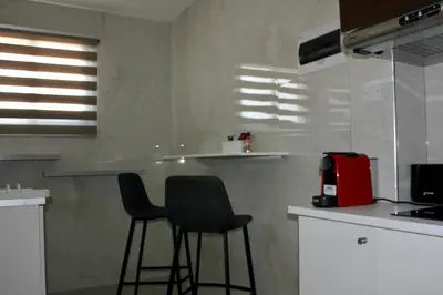 a kitchen with two chairs and a red appliance at Nicosia Central Suites in Nicosia
