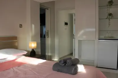 a bedroom with a bed with two towels on it at Nicosia Central Suites in Nicosia