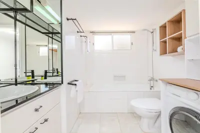 a white bathroom with a sink and a toilet at La Casa De Louie in Ayia Napa