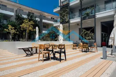 a table and chairs in front of a building at SunnyVillas Suite Mythical GYM Swimming Pool S21 in Paralimni