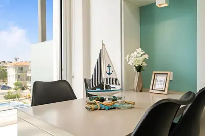 a dining room table with a model boat on it at SunnyVillas Suite Mythical GYM Swimming Pool S21 in Paralimni