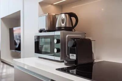 a microwave sitting on top of a kitchen counter at SunnyVillas Suite Mythical GYM Swimming Pool S21 in Paralimni