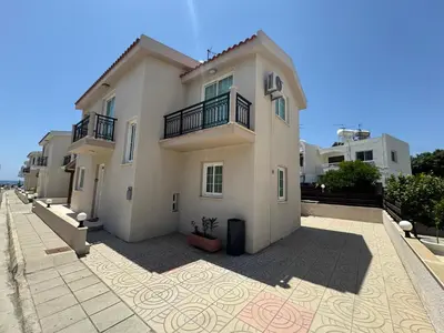 a large white building with two balconies on it at Sea side House in Voroklini