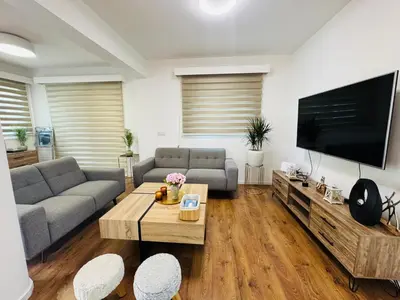 a living room with a couch and a tv at Sea side House in Voroklini