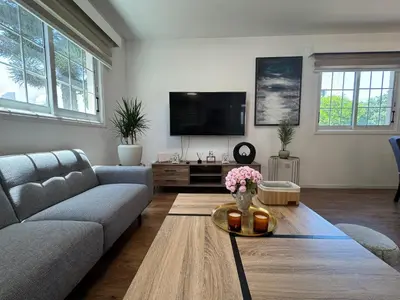 a living room with a couch and a tv at Sea side House in Voroklini