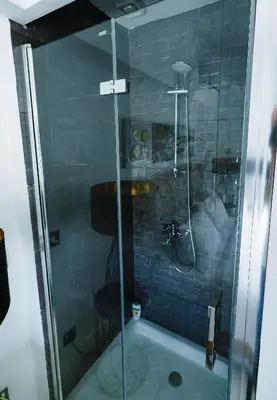 a shower with a glass door in a bathroom at Bloom of Luxury in Limassol
