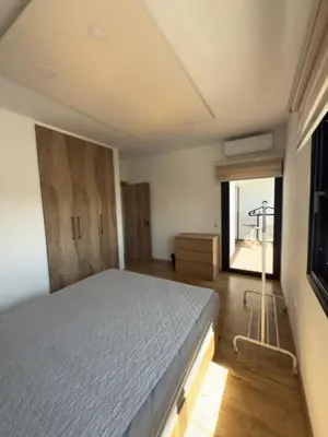 a bedroom with a large bed and a window at Stylish 2 bedroom apartment in Limassol in Limassol