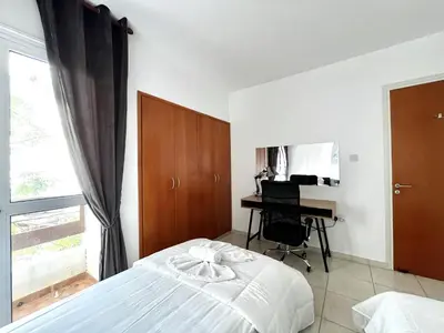 a bedroom with a bed and a desk and a window at STAY Napa Dreams Apartment in Ayia Napa