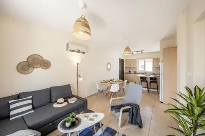 a living room with a couch and a table at SunnyVillas 2BR Mythical Apt Swimming Pool BF03 in Paralimni