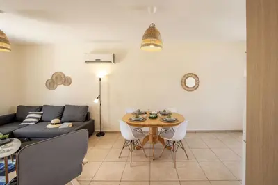 a living room with a table and a couch at SunnyVillas 2BR Mythical Apt Swimming Pool BF03 in Paralimni