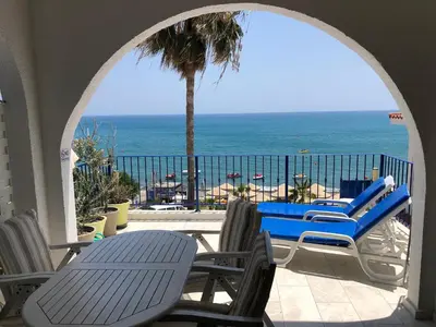 a patio with chairs and a view of the ocean at Pissouri Beach Front Apartments in Pissouri