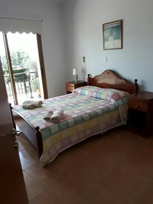 a bedroom with a bed with two pillows on it at Yialos Apartments in Pissouri