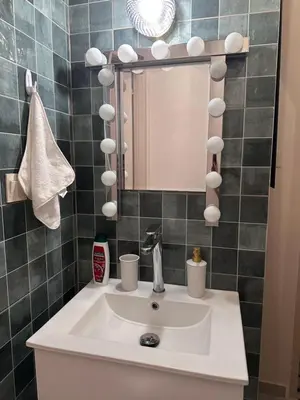 a bathroom with a sink and a mirror at Mavrommati Luxury Residence no1 in Limassol