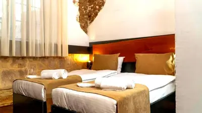 two beds in a hotel room with white sheets at 22 Yedia North Nicosia Turkish Side in Nicosia